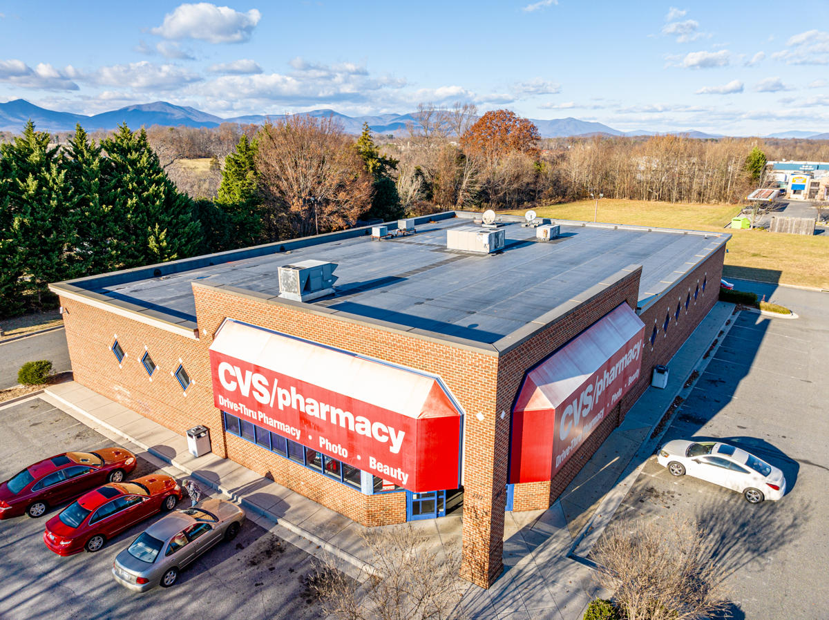 Aerial view of a CVS pharmacy building with parked cars and surrounding trees